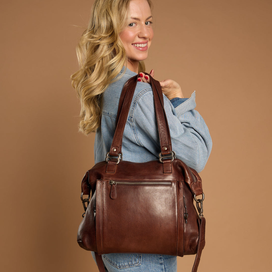 Brown full-grain leather Athena concealed carry tote bag on model by Confident Conceal