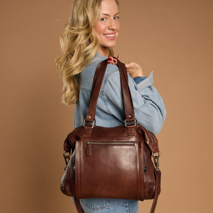 Brown full-grain leather Athena concealed carry tote bag on model by Confident Conceal